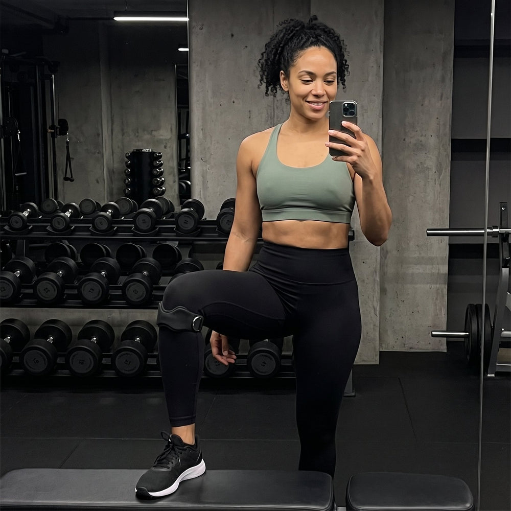Woman at the gym wearing the KneeLock strap over her leggings